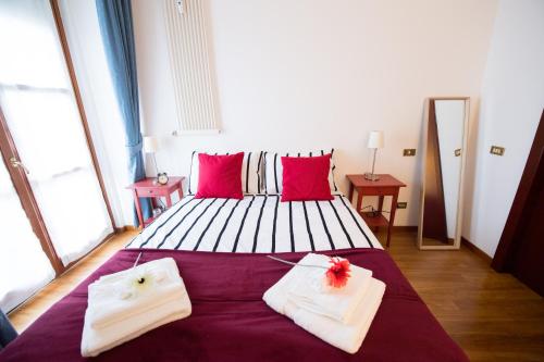 a bedroom with a large bed with red pillows at Airguest Crocetta loft in Milan