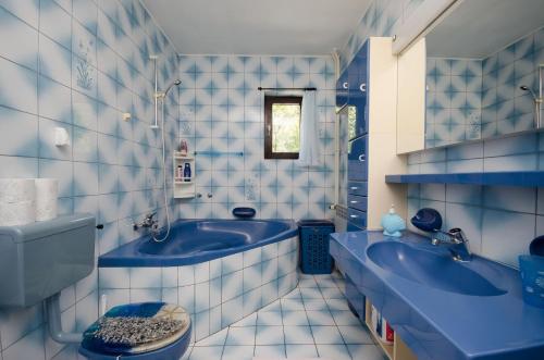 a blue bathroom with two sinks and a tub at Apartment Katarina in Crikvenica