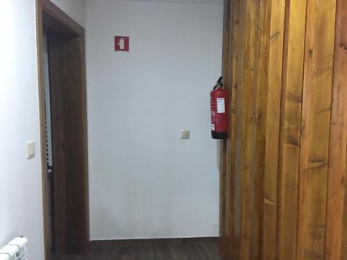 a fire hydrant is on the wall next to a door at Refúgio dos Macedos in Bilhó
