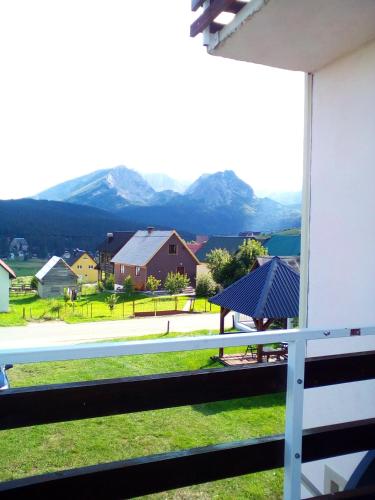 a view from the balcony of a house with mountains in the background at Guesthouse Mijatovic in Žabljak