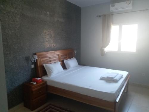 Un pat sau paturi într-o cameră la Hotel La Perle