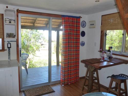 a kitchen with a sliding glass door to a deck at Excelente Cabaña Cumbre del Diablo 2 in Punta Del Diablo