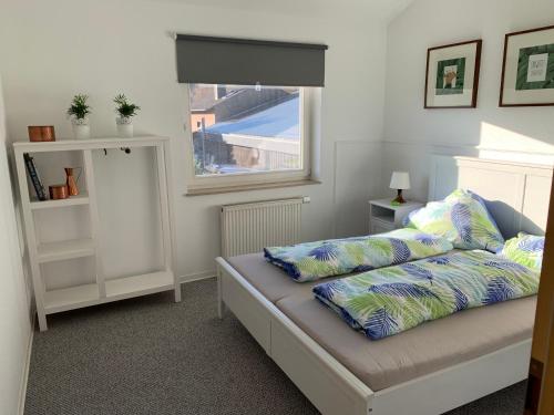 a bedroom with a bed with pillows on it at Ferienwohnung Blütenstadt in Leichlingen