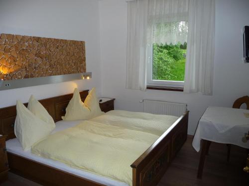 a bedroom with a large bed and a window at Familiengasthof St. Wolfgang in Spittal an der Drau