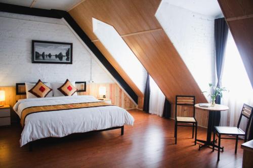 a bedroom with a large bed in a attic at AROMA Ha Long Hotel in Ha Long