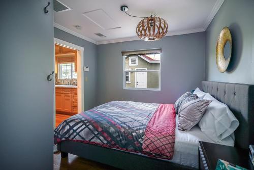 a bedroom with a bed and a chandelier at Stylish 2 Bed & 2 Bath at the Heart of Hollywood with Free Parking - One Car only in Los Angeles