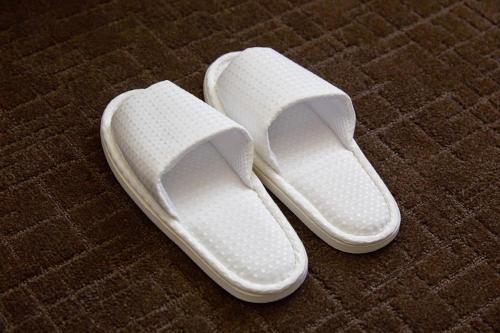 a pair of white shoes sitting on a carpet at Hotel Forza Nagasaki in Nagasaki