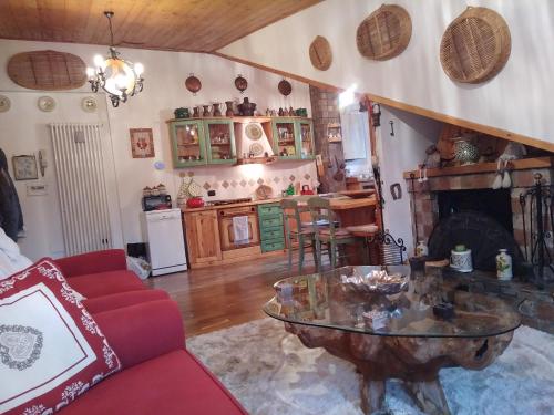 a living room with a table and a fireplace at Pescocostanzo Appartamenti in Pescocostanzo