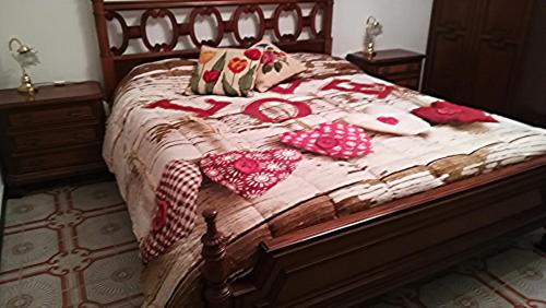 a bed with two valentines pillows on it at Alassio Mare e non Solo in Alassio
