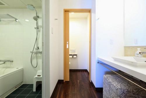 a bathroom with a sink, toilet and bathtub at Hotel Forza Nagasaki in Nagasaki