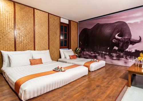 En eller flere senge i et værelse på Dang Derm Khaosan