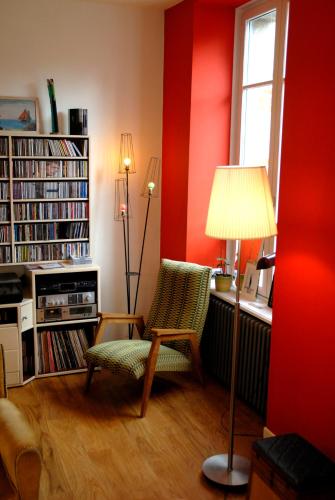 a living room with a chair and a lamp at Gai Séjour in Étables-sur-Mer