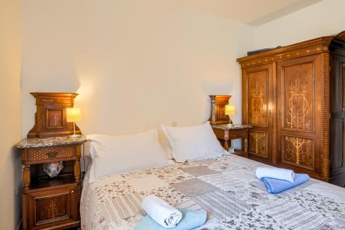 a bedroom with a wooden bed with two pillows on it at Apartments Frlan in Kastav