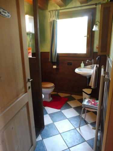 a bathroom with a toilet and a sink at Alle porte di Marano in Marano