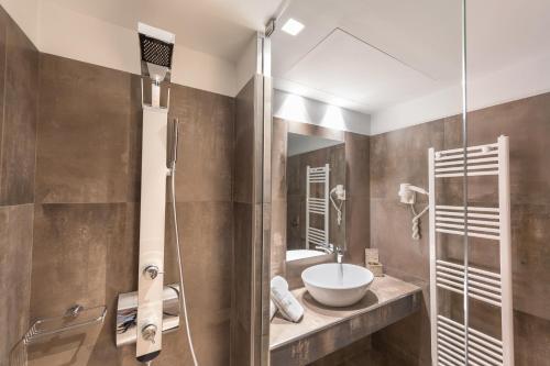 a bathroom with a sink and a glass shower at Castello Hotel in Rio