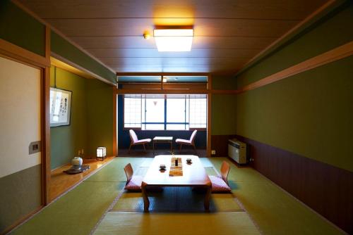 a living room with a table and a couch at Meitoya So in Zao Onsen