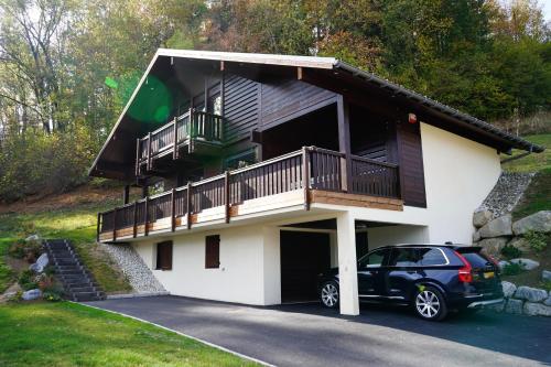 a house with a car parked in front of it at Chalet Kizuna in Saint-Gervais-les-Bains