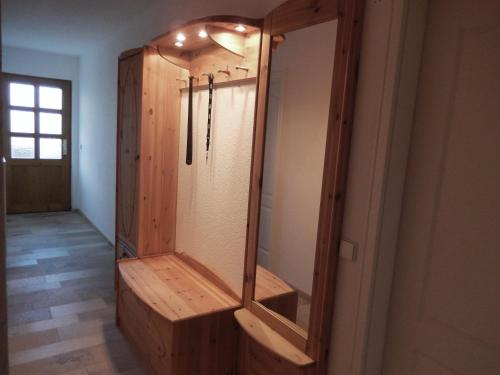 a wooden dressing room with a mirror on the wall at Zum Elleblick in Frauenstein