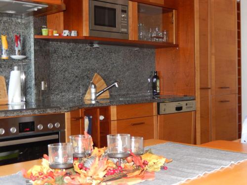 a kitchen with a table with glasses on it at Zum Elleblick in Frauenstein