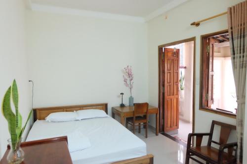 a bedroom with a bed and a table and chairs at Moon house tropical garden - Valentine in Nha Trang