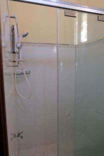 a shower stall with a glass door in a bathroom at Moon house tropical garden - Valentine in Nha Trang