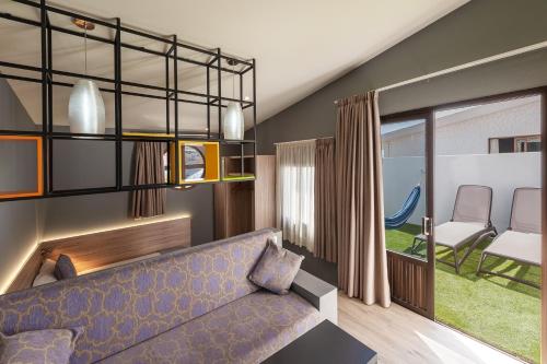 a living room with a blue couch and a table at Apartamentos NataLis in Morro del Jable
