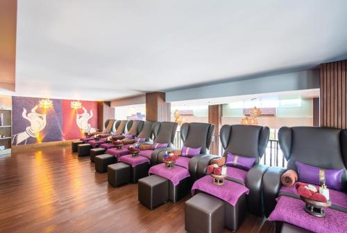a row of chairs in a room with purple seats at Anchan Hotel & Spa in Hua Hin