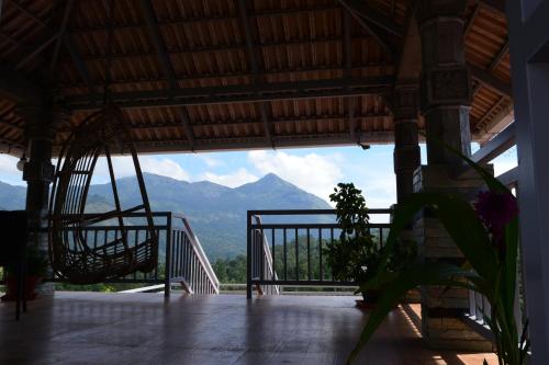 a view from the inside of a building with a mountain at Zenha Resorts in Munnar