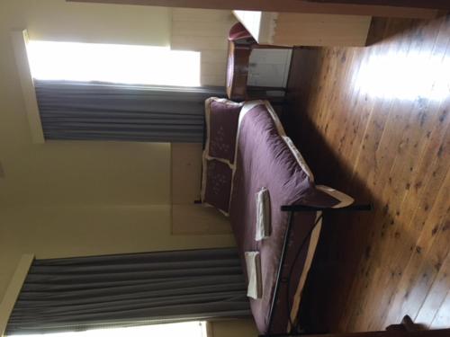 two bunk beds in a room with a window at Holmhurst Guest House in Bathurst