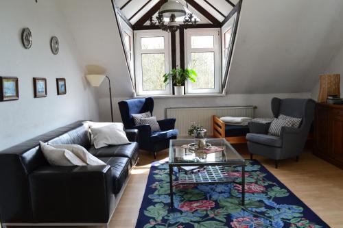 a living room with a couch and chairs and a table at Farm stay Hof auf der Wurp in Harrierwurp
