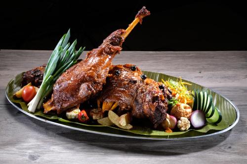 two pieces of meat on a plate of food at Golden Prince Hotel & Suites in Cebu City