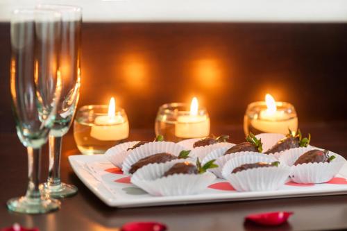 a plate of cupcakes and candles on a table at Hotel Arizona Suites Cúcuta in Cúcuta