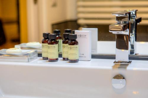 four bottles of essential oils sitting on a table at App Beccaria Apartments in Rome in Rome
