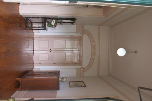 a room with a table and a cabinet at Holmhurst Guest House in Bathurst