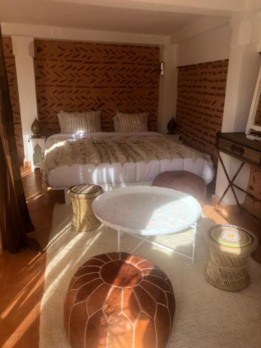 1 dormitorio con 1 cama y 1 mesa enfrente en Riad Dar Zioui, en Marrakech