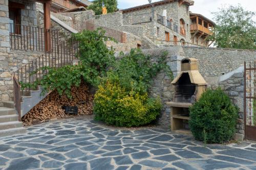 a stone wall with a staircase and a bench at Aparthotel Bellver in Bellver de Cerdanya 