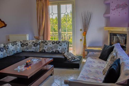 ANEMOS HOLIDAYS HOUSE في Kypseli: غرفة معيشة مع أريكة وطاولة