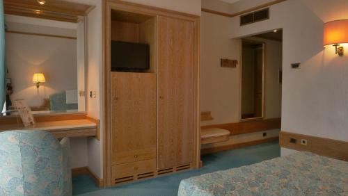a hotel room with a bedroom with a bed and a television at 501 Hotel in Vibo Valentia