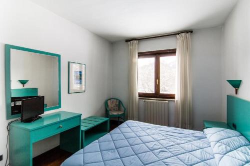 Un pat sau paturi într-o cameră la Hotel Verdeneve