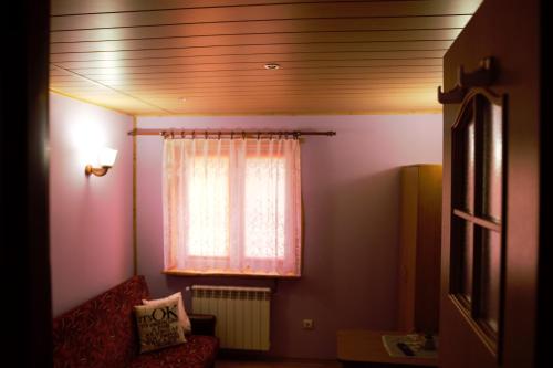 a living room with a window and a red couch at U Jędrusia in Polańczyk