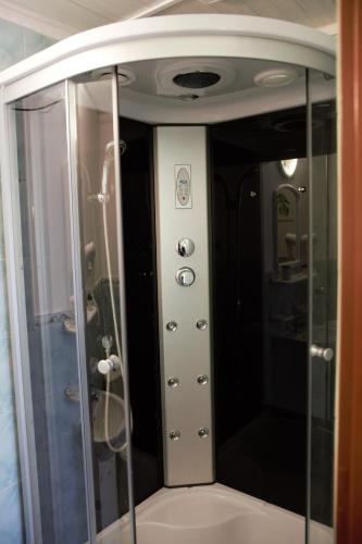 a shower with a glass door in a bathroom at U Jędrusia in Polańczyk
