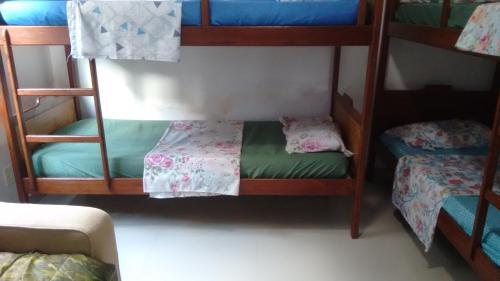 a room with three bunk beds in a room at Casa temporada in Arraial do Cabo