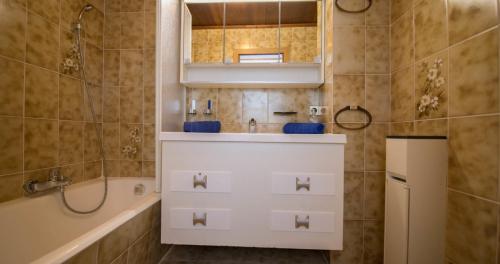 a bathroom with a sink and a tub and a shower at Haus Binder in Weissensee