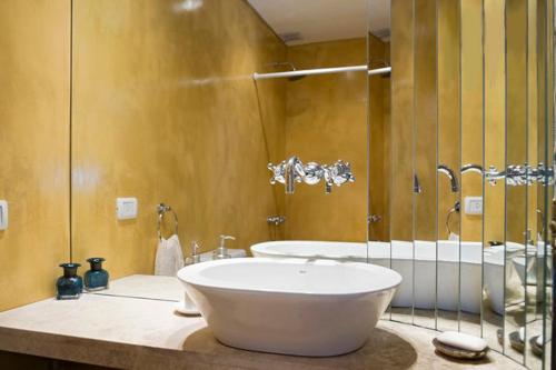 a bathroom with a large white sink and a tub at LOFT ALMAGRO in Buenos Aires