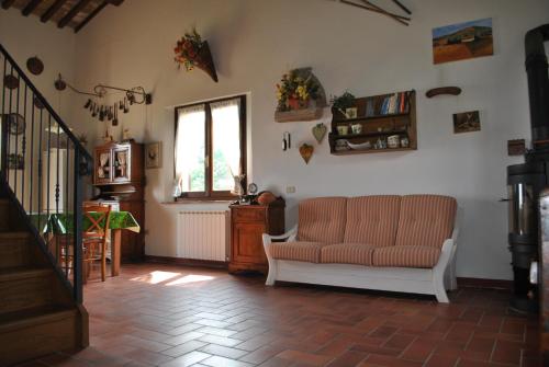 a living room with a couch and a window at CASADILUPPE in Roccatederighi
