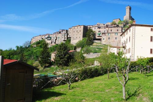 a group of buildings on top of a hill at CASADILUPPE in Roccatederighi