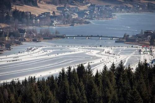 a group of people on a ski slope in the snow at Haus Binder in Weissensee