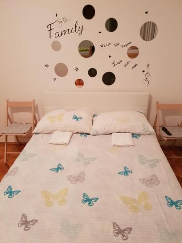 a bedroom with a bed with planets on the wall at De lux Apartment & Rooms Emilia in Banja Luka