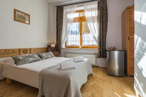 Кровать или кровати в номере Pokoje i Apartamenty Krupówki 36