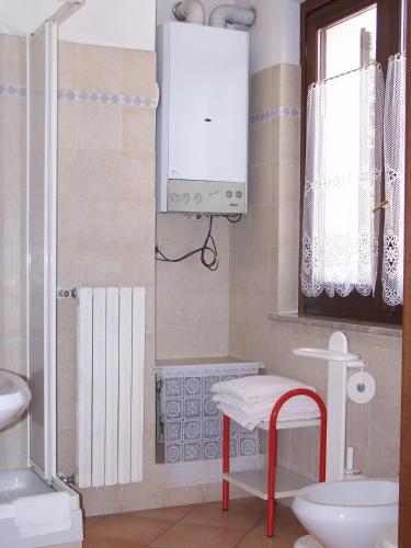 a bathroom with a sink and a toilet and a mirror at Hotel Ristorante La Torretta in Bianzè
